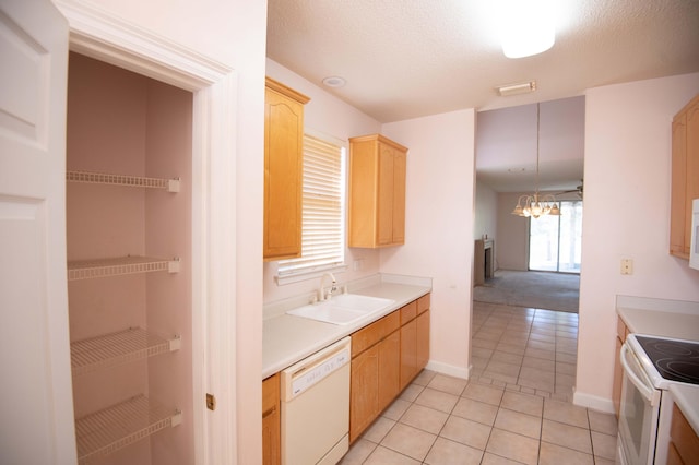 kitchen with light brown cabinets, white appliances, sink, light tile patterned floors, and a notable chandelier