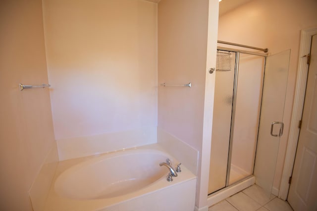 bathroom with tile patterned flooring and separate shower and tub