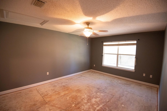 unfurnished room with ceiling fan and a textured ceiling