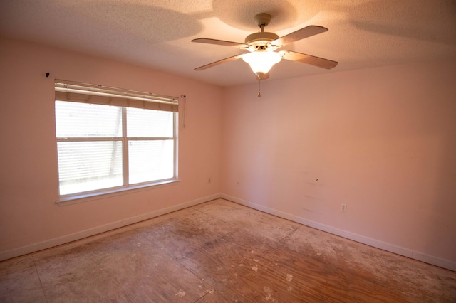 empty room featuring ceiling fan and a textured ceiling