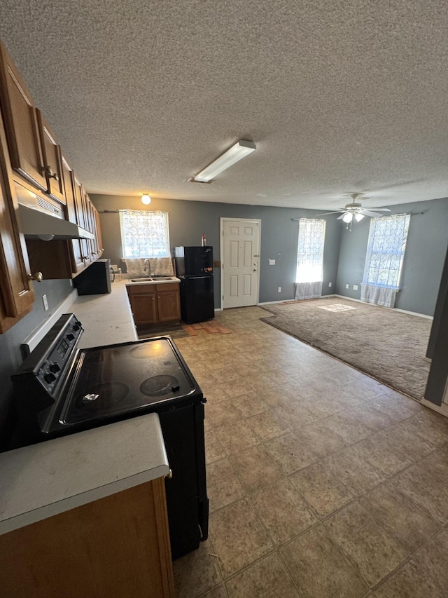 kitchen featuring a textured ceiling, sink, ceiling fan, and black appliances