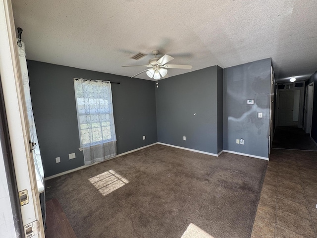 spare room featuring a textured ceiling and ceiling fan