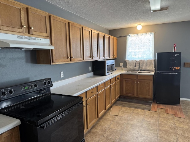 kitchen featuring black appliances, sink, and a textured ceiling