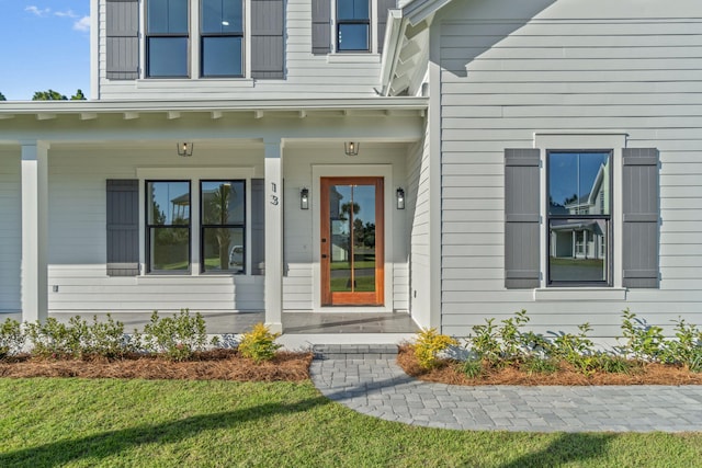 property entrance with a lawn