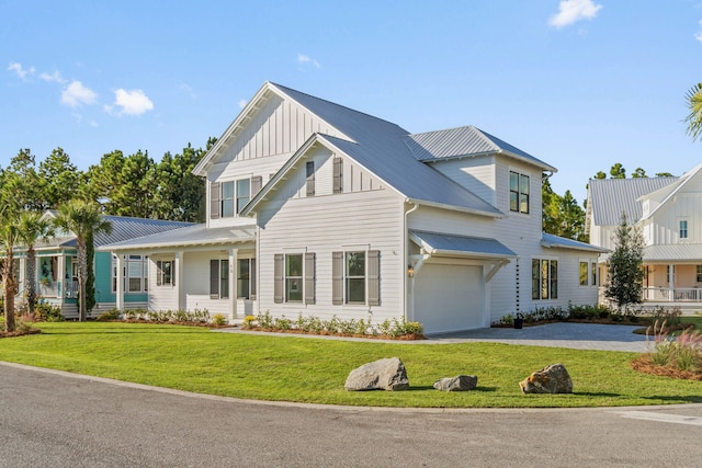 view of front facade with a front yard, a garage, and covered porch