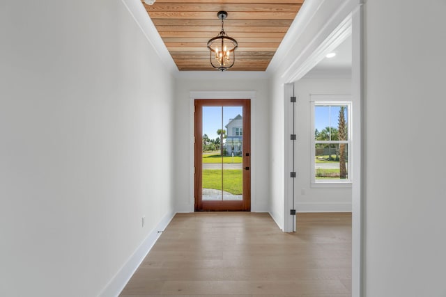 doorway to outside featuring light wood-type flooring, crown molding, a wealth of natural light, and wooden ceiling