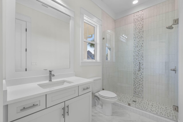 bathroom with a shower with door, vanity, and toilet