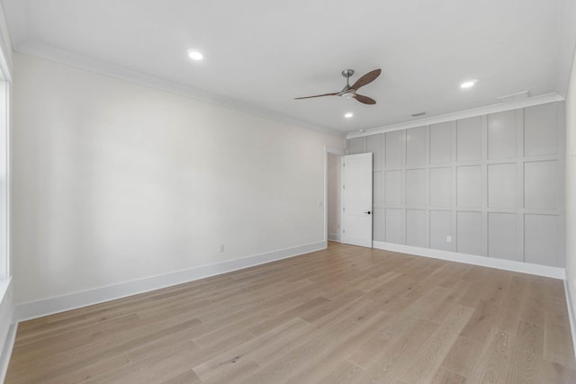 empty room with ceiling fan, light wood-type flooring, and ornamental molding