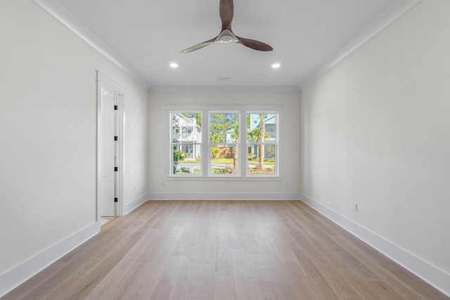 empty room with ceiling fan, ornamental molding, and light wood-type flooring