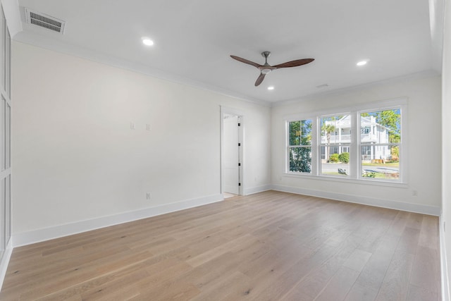 spare room featuring light hardwood / wood-style floors, ceiling fan, and crown molding