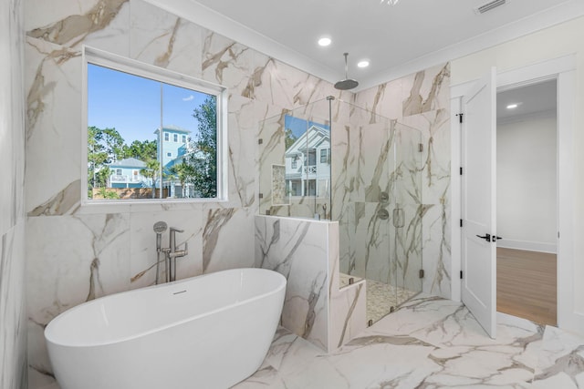 bathroom with separate shower and tub and ornamental molding