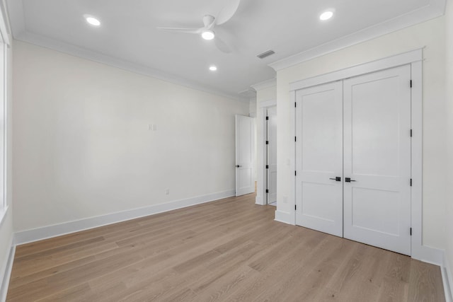 unfurnished bedroom featuring ceiling fan, a closet, light hardwood / wood-style floors, and ornamental molding