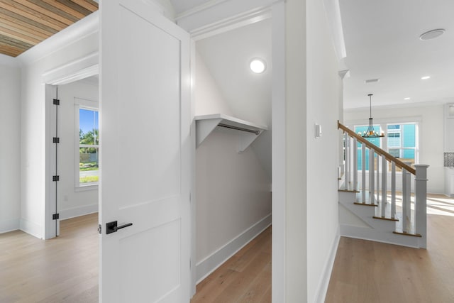 staircase featuring a notable chandelier and wood-type flooring