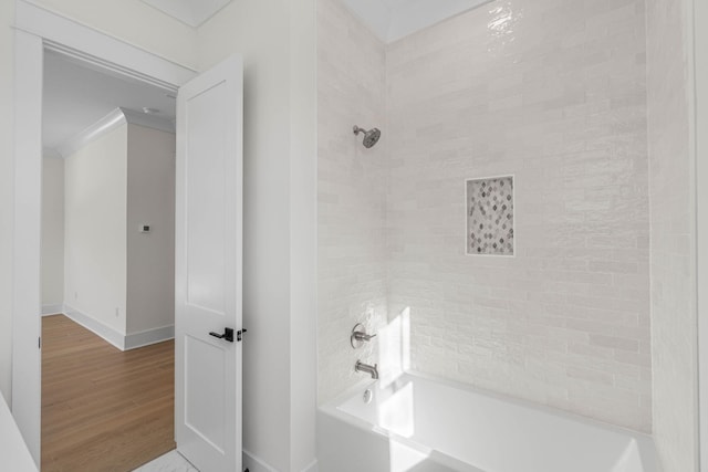 bathroom with hardwood / wood-style flooring and crown molding