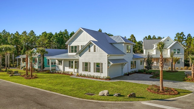 view of front of property with a garage and a front yard