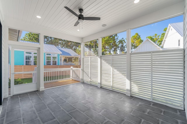 unfurnished sunroom featuring ceiling fan and wooden ceiling