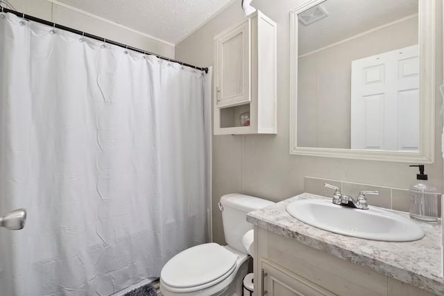 bathroom with vanity, ornamental molding, a textured ceiling, and toilet