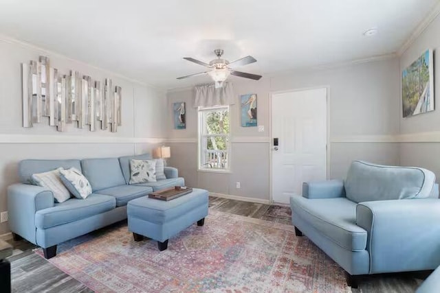 living room with hardwood / wood-style flooring, ceiling fan, and crown molding