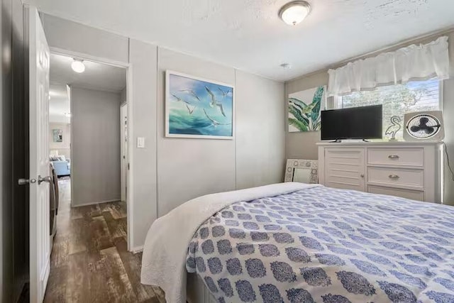 bedroom with dark hardwood / wood-style floors