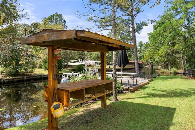 view of property's community with a water view and a yard