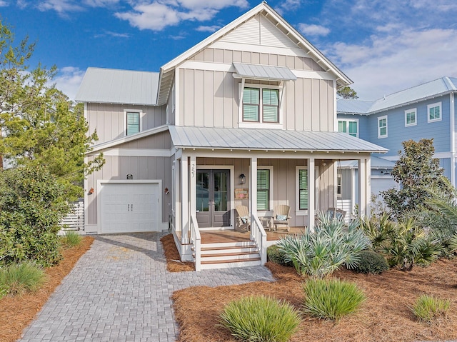 modern farmhouse style home with covered porch and a garage