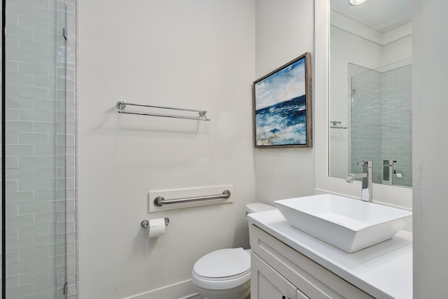 bathroom featuring vanity, toilet, and a shower with shower door