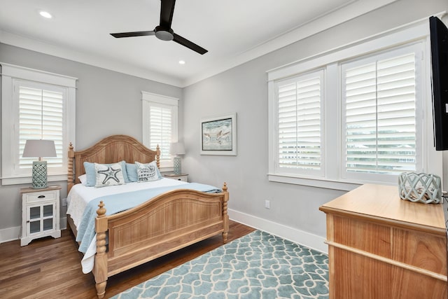 bedroom featuring dark hardwood / wood-style floors, ceiling fan, and ornamental molding