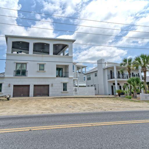 view of front of property with a balcony and a garage