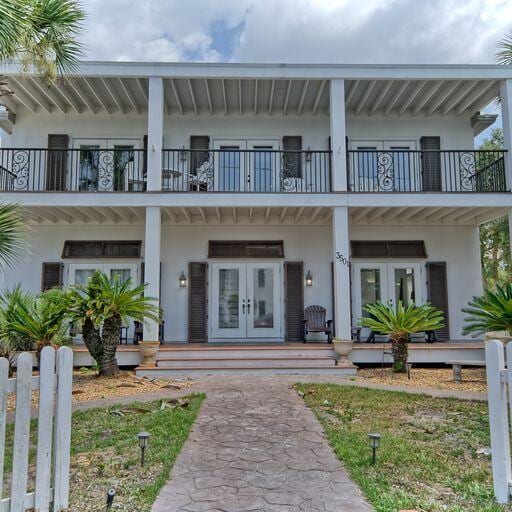 exterior space featuring french doors and a balcony