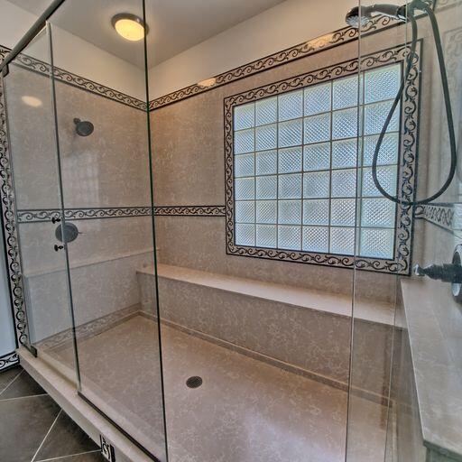 bathroom featuring tile patterned flooring and a shower with door