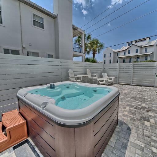 view of patio / terrace with central AC and a hot tub