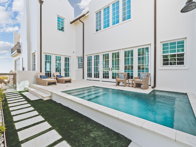 rear view of property featuring a patio and french doors