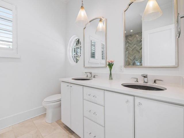 bathroom with vanity, a healthy amount of sunlight, tile patterned floors, and toilet