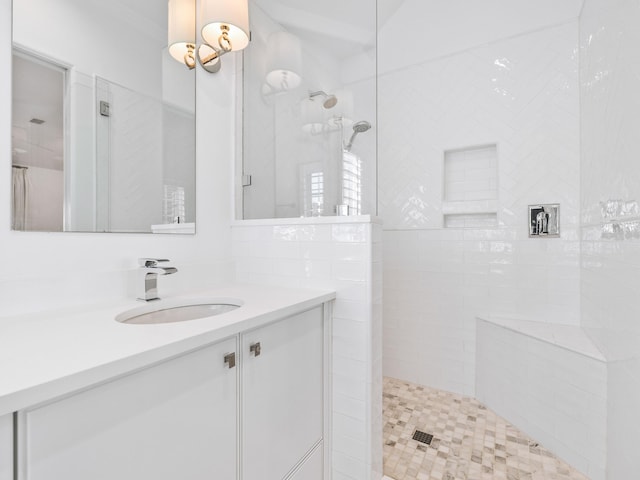 bathroom with vanity and tiled shower