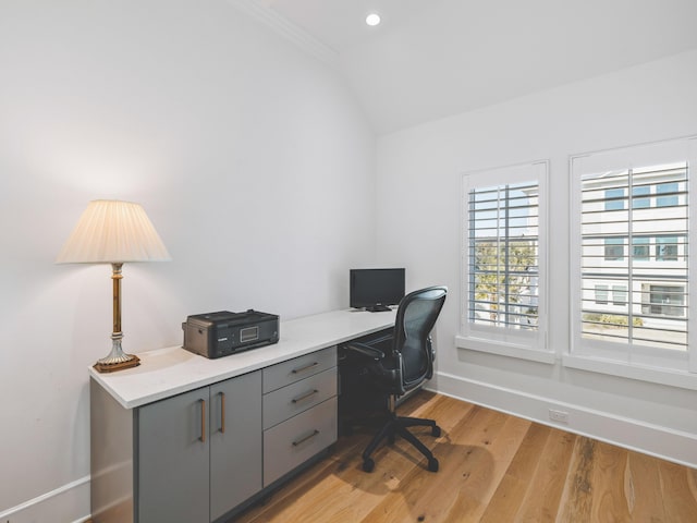 office featuring ornamental molding, lofted ceiling, and light wood-type flooring