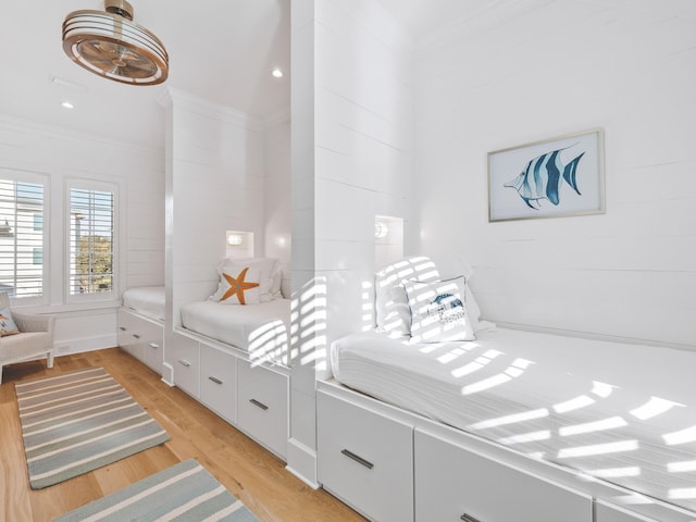 bedroom featuring ornamental molding and light hardwood / wood-style floors