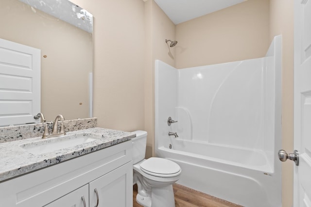 full bathroom with wood-type flooring, shower / tub combination, vanity, and toilet