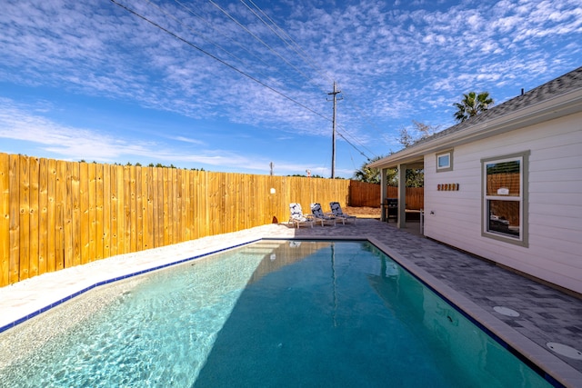 view of swimming pool featuring grilling area