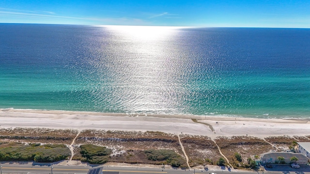 birds eye view of property featuring a beach view and a water view