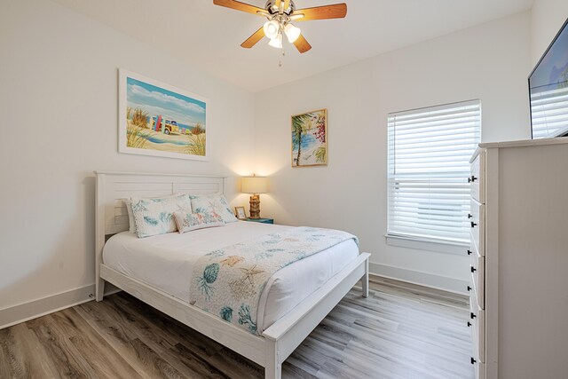 bedroom featuring ceiling fan and hardwood / wood-style floors