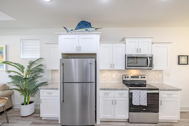 kitchen featuring appliances with stainless steel finishes and white cabinetry