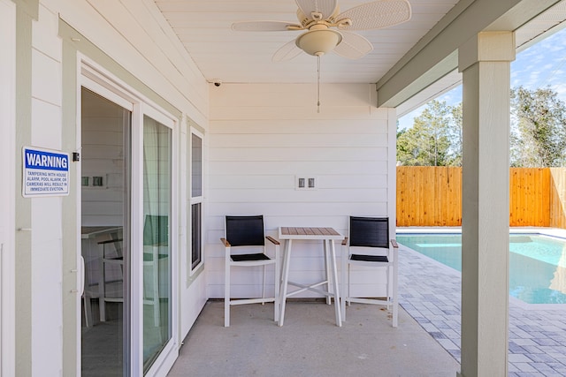 view of patio with a fenced in pool and ceiling fan