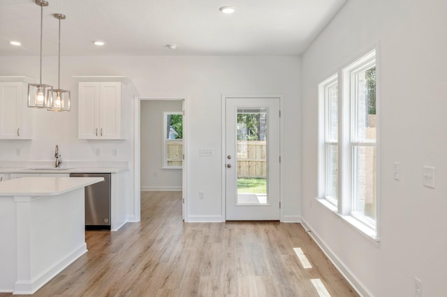 LOT7 Tansey St, Crestview, FL 32539 - kitchen with white cabinetry, stainless steel dishwasher, a healthy amount of sunlight, and hanging light fixtures