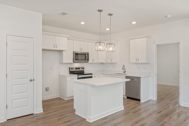 LOT7 Tansey St, Crestview, FL 32539 - kitchen featuring decorative light fixtures, a kitchen island, stainless steel appliances, and white cabinetry