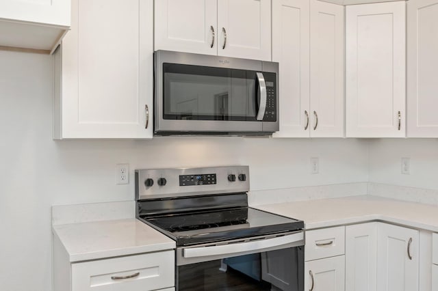 LOT7 Tansey St, Crestview, FL 32539 - kitchen featuring appliances with stainless steel finishes, white cabinetry, and light stone countertops