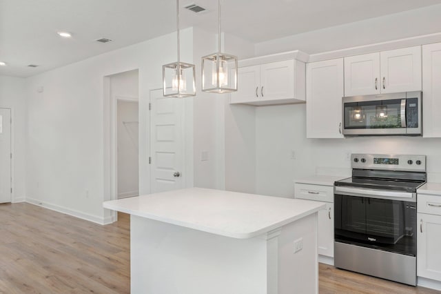 LOT7 Tansey St, Crestview, FL 32539 - kitchen with stainless steel appliances, pendant lighting, white cabinetry, and a kitchen island