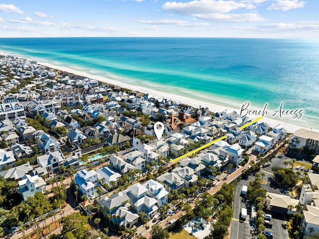 birds eye view of property featuring a beach view and a water view