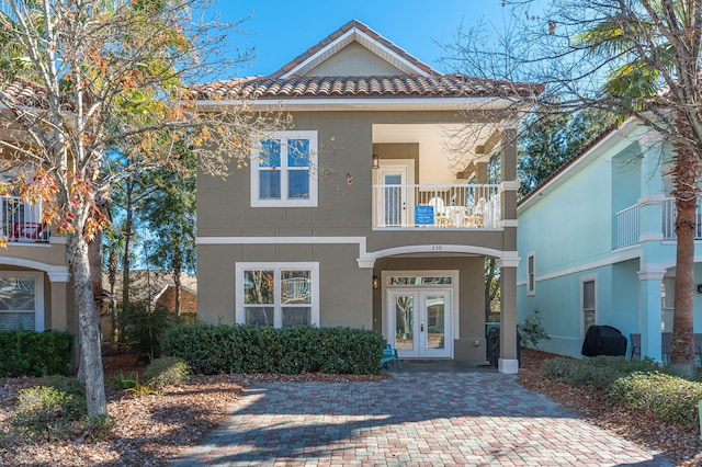 view of front of house with french doors and a balcony