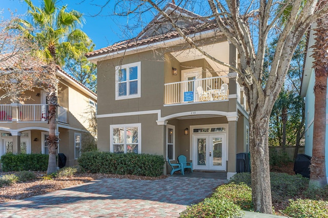 view of front of house featuring french doors and a balcony