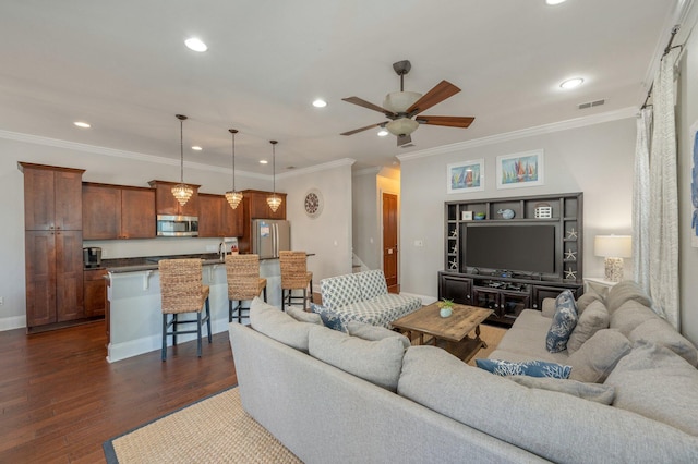 living room with dark hardwood / wood-style flooring, ceiling fan, and ornamental molding